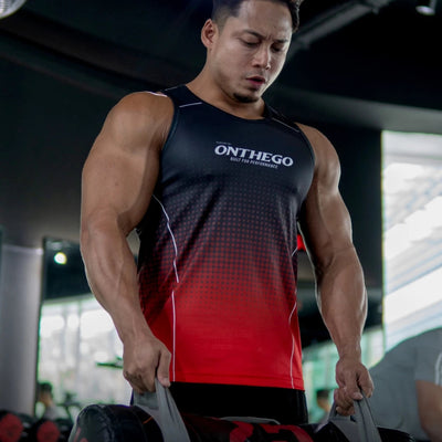 Muscular man in a gym wearing an 'ONTHEGO' tank top, holding weights.